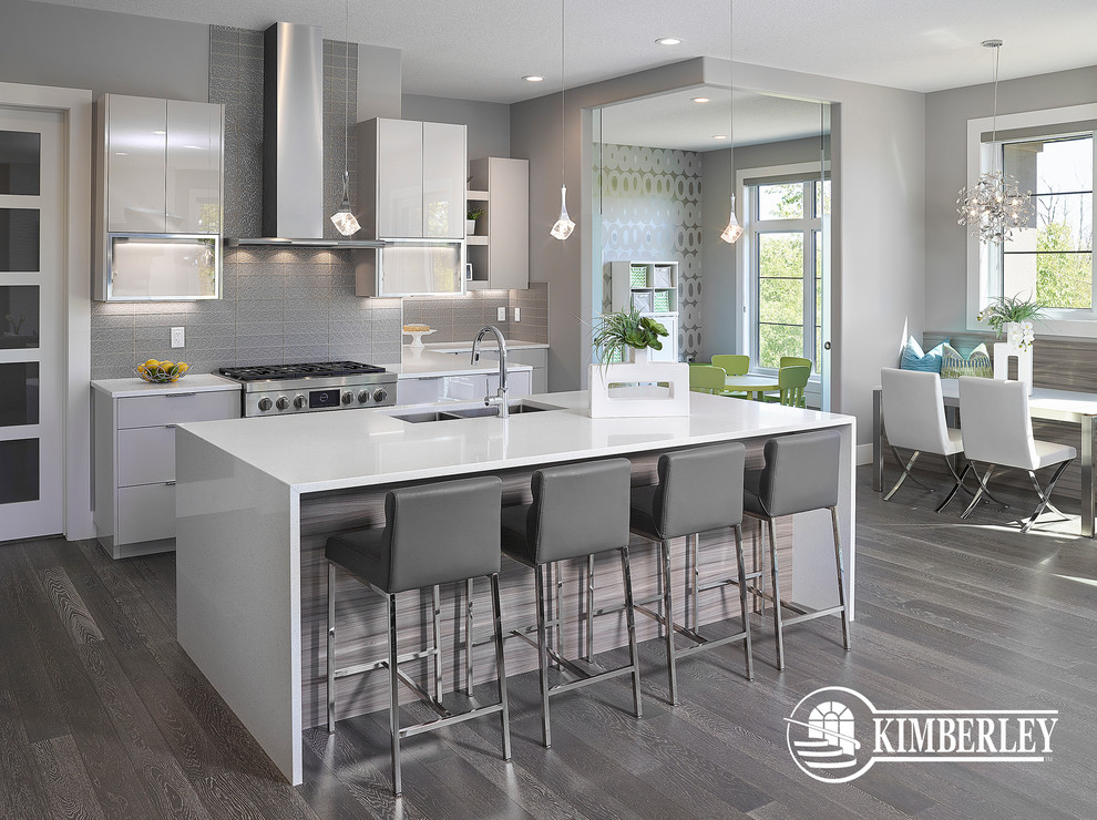 Inspiration for a large contemporary l-shaped eat-in kitchen in Edmonton with an undermount sink, flat-panel cabinets, white cabinets, grey splashback, glass tile splashback, stainless steel appliances, dark hardwood floors and with island.