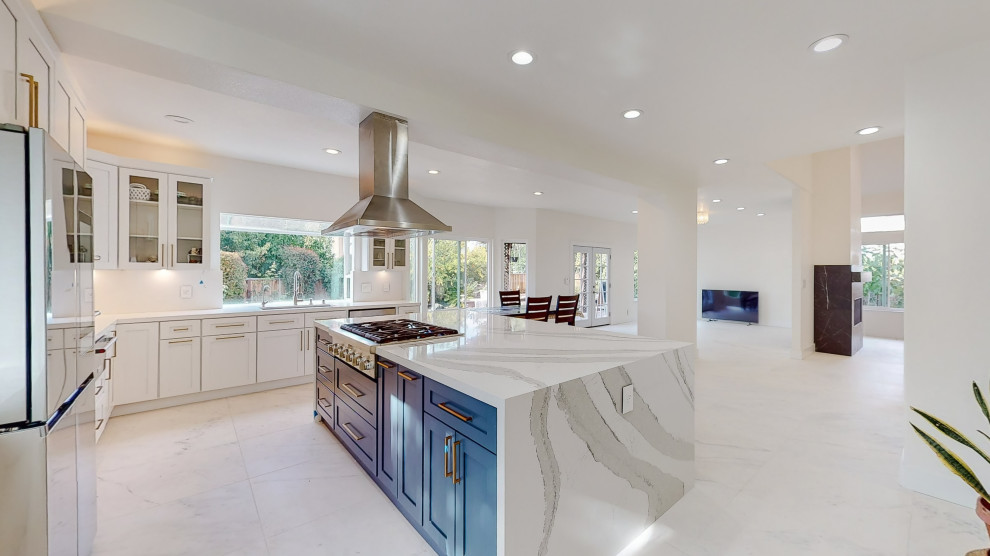 Minimalist porcelain tile and beige floor eat-in kitchen photo in San Francisco with an undermount sink, raised-panel cabinets, blue cabinets, marble countertops, white backsplash, mosaic tile backsplash, white appliances and white countertops