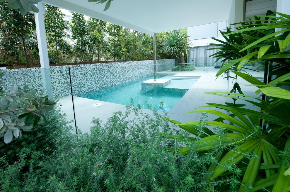This is an example of a mid-sized contemporary front yard l-shaped pool in Sunshine Coast with tile.
