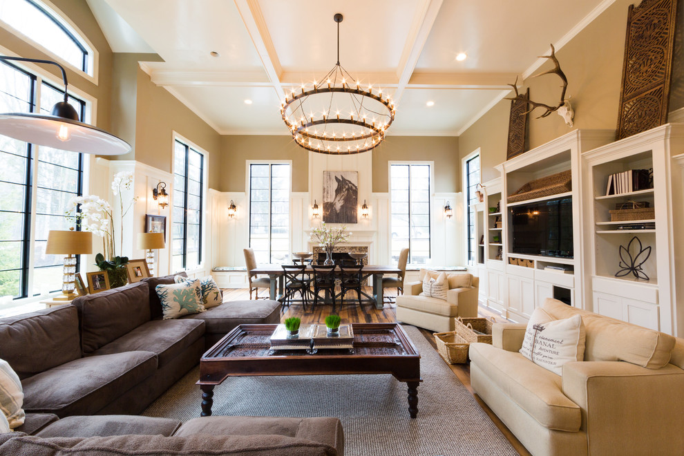 Large elegant formal and open concept medium tone wood floor living room photo in Indianapolis with beige walls and a media wall