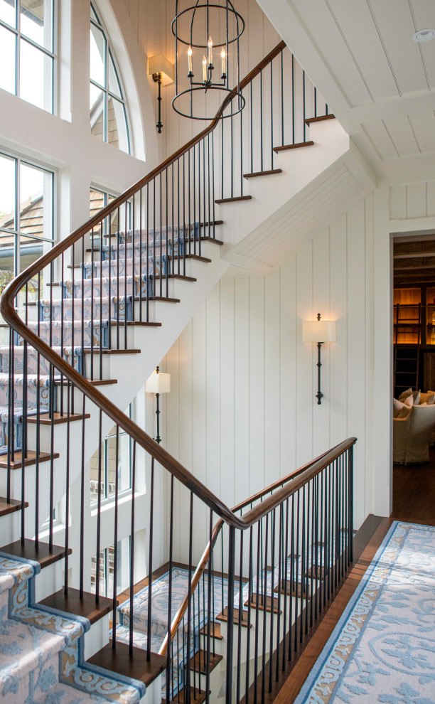 Staircase - coastal carpeted floating wood railing staircase idea in Charleston with carpeted risers