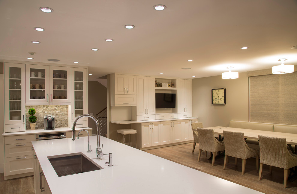 Example of a large transitional medium tone wood floor and brown floor enclosed dining room design in Denver with beige walls