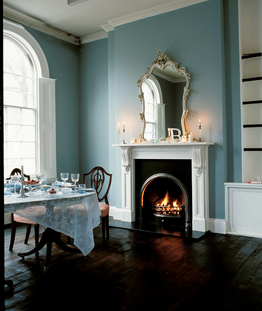 Inspiration for a large traditional open plan dining in San Francisco with a standard fireplace, a metal fireplace surround, blue walls and dark hardwood floors.