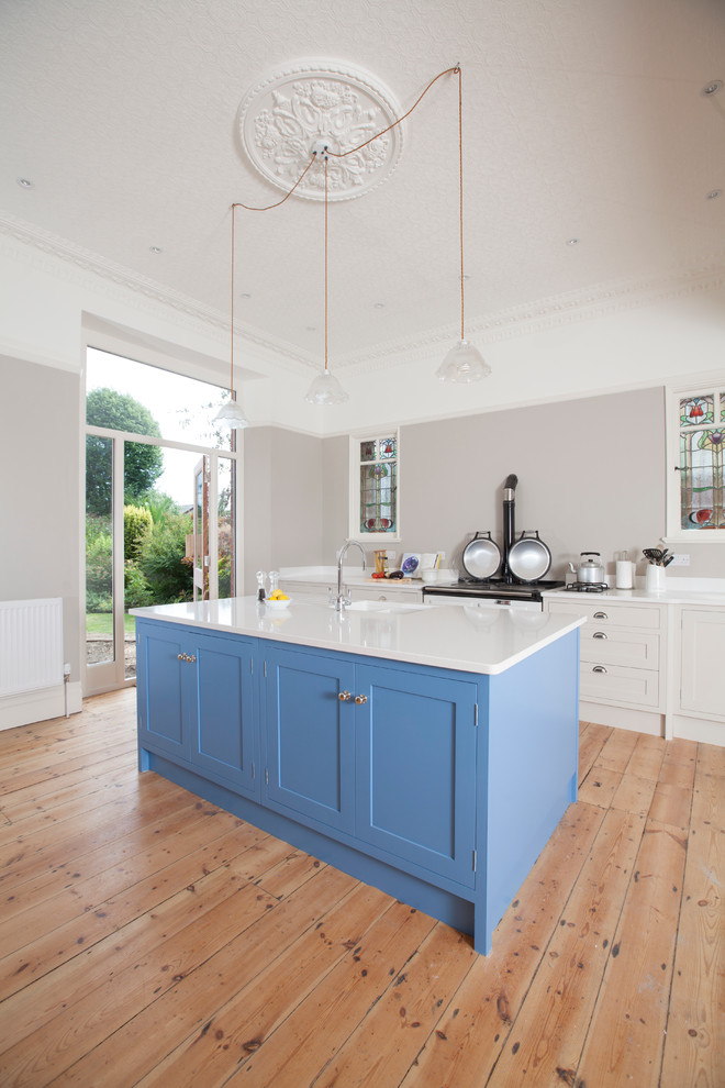 Design ideas for a traditional single-wall open plan kitchen in Cardiff with an undermount sink, shaker cabinets, white cabinets, quartzite benchtops, coloured appliances and with island.