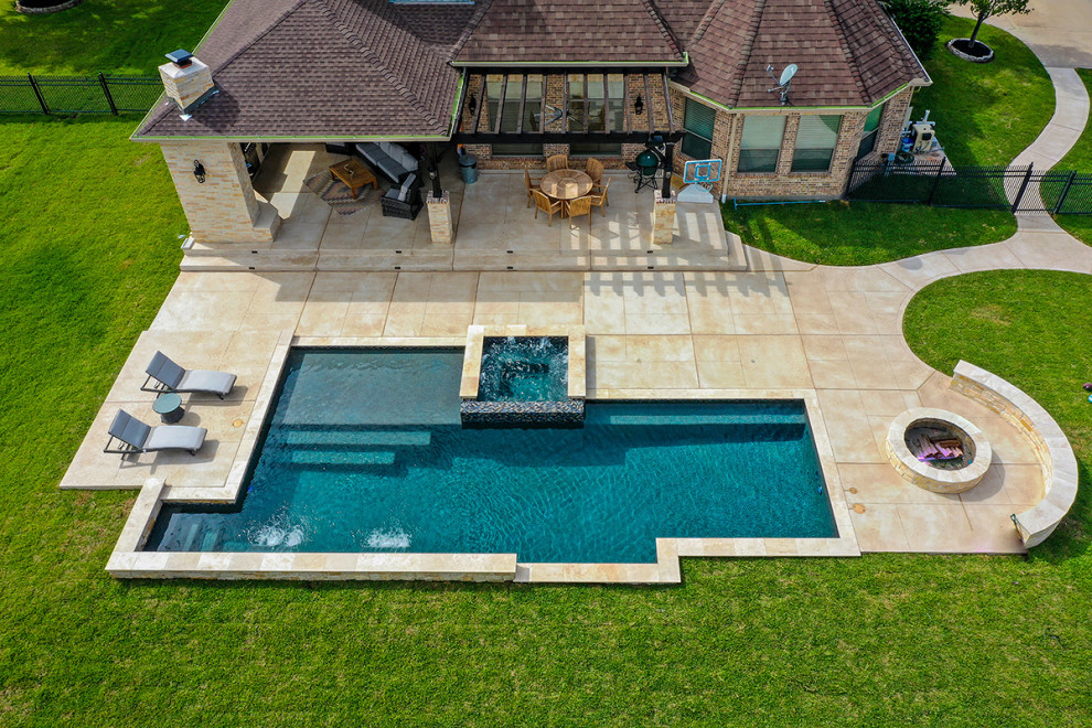 Large traditional back rectangular above ground swimming pool in Houston with with pool landscaping and natural stone paving.