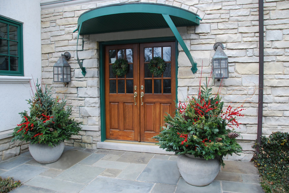 This is an example of a large country white exterior in Chicago with stone veneer.