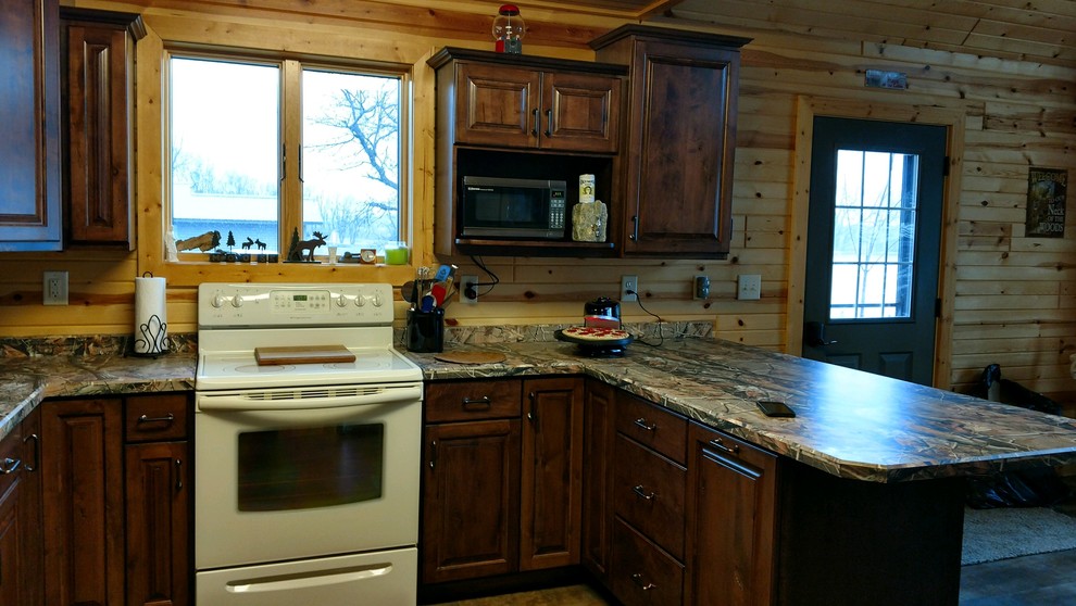 Inspiration for a small timeless u-shaped medium tone wood floor and brown floor enclosed kitchen remodel with raised-panel cabinets, a double-bowl sink, dark wood cabinets, laminate countertops, brown backsplash, wood backsplash, white appliances and a peninsula