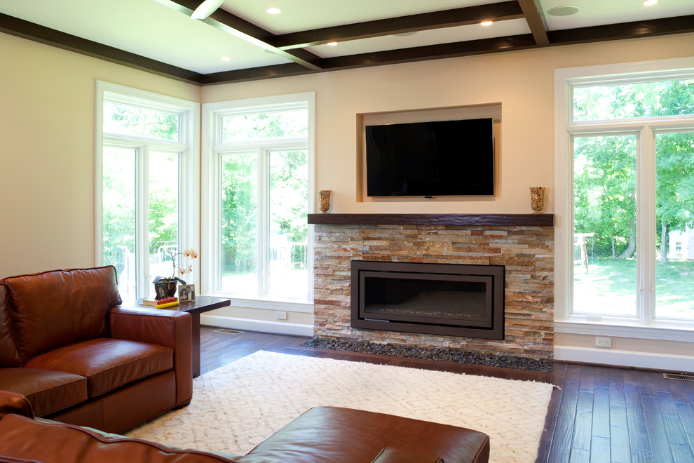 Design ideas for a mid-sized transitional enclosed family room in DC Metro with beige walls, dark hardwood floors, a ribbon fireplace, a stone fireplace surround, a wall-mounted tv and brown floor.