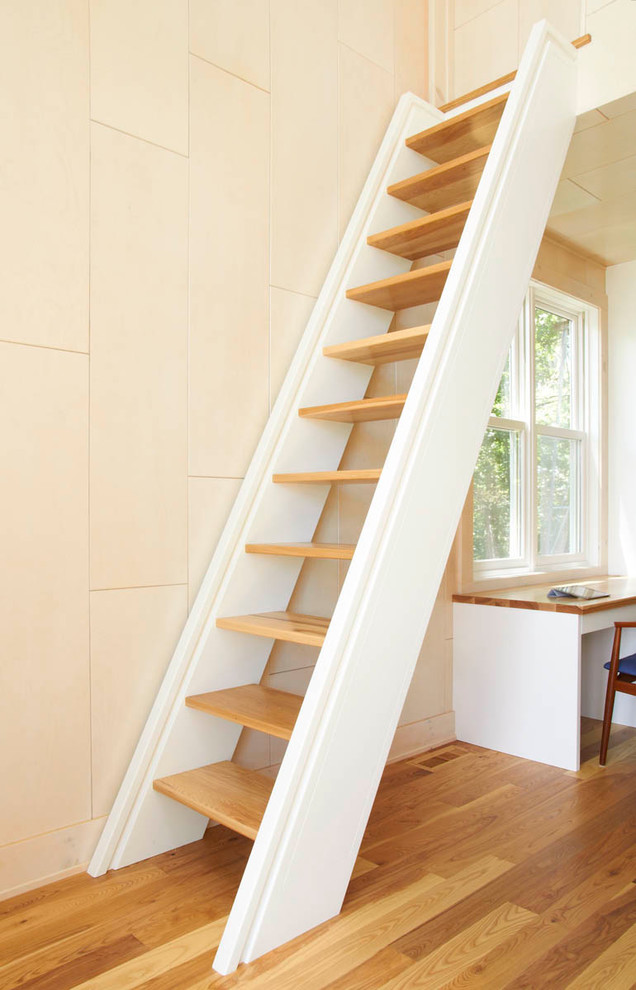 Photo of a modern wood straight staircase in Minneapolis with open risers.
