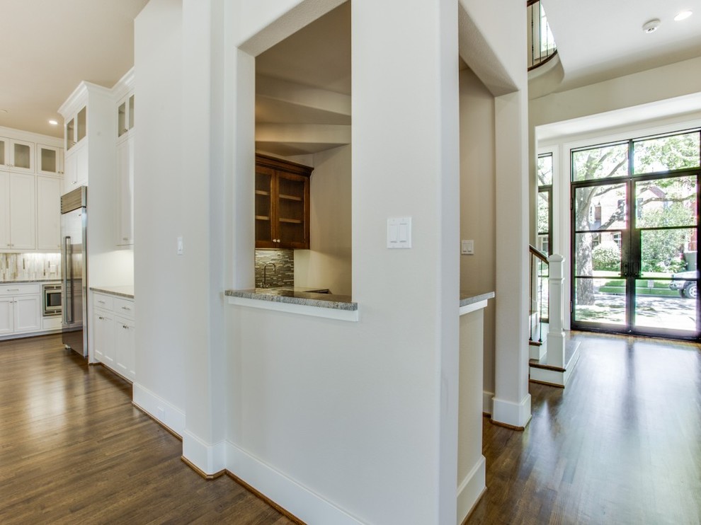 Mid-sized transitional medium tone wood floor front door photo in Dallas with beige walls and a metal front door
