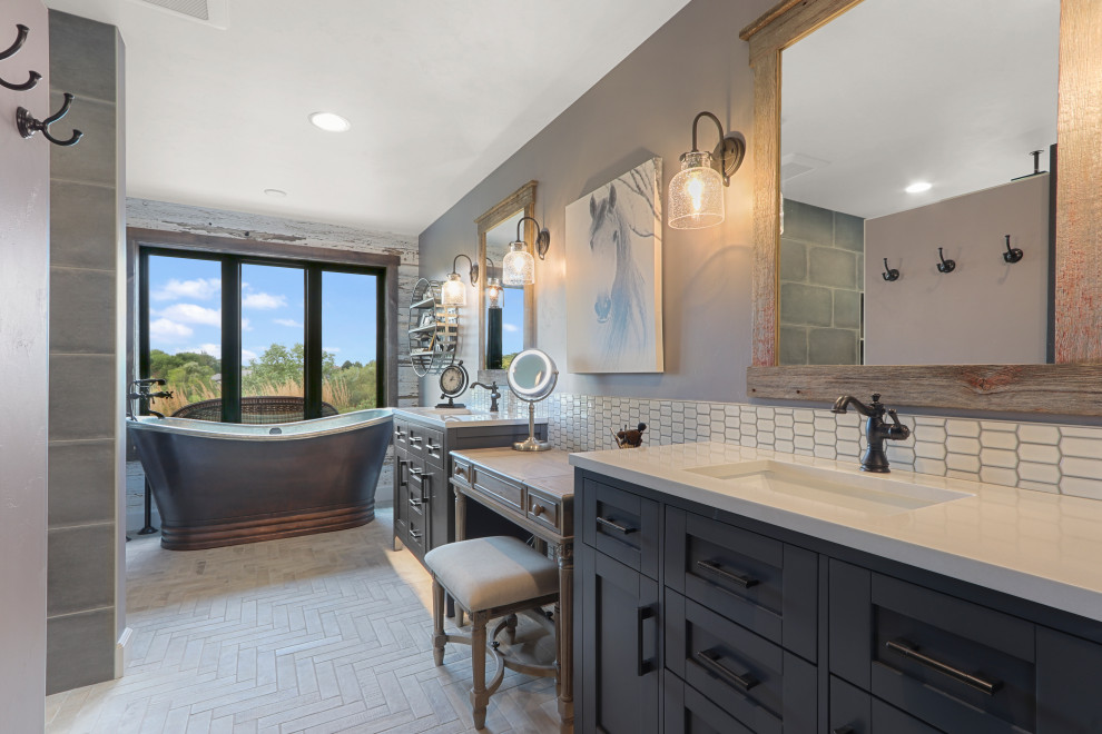 Photo of a country master bathroom in Other with shaker cabinets, grey cabinets, a freestanding tub, grey walls, an undermount sink, grey floor and white benchtops.