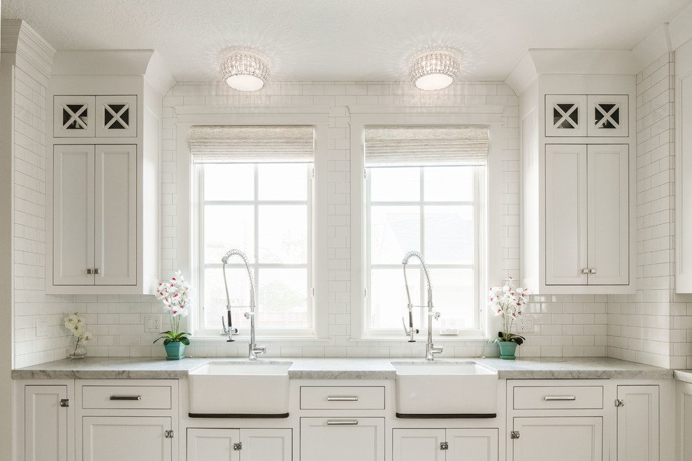 This is an example of a traditional kitchen in Salt Lake City with a farmhouse sink, recessed-panel cabinets and white cabinets.