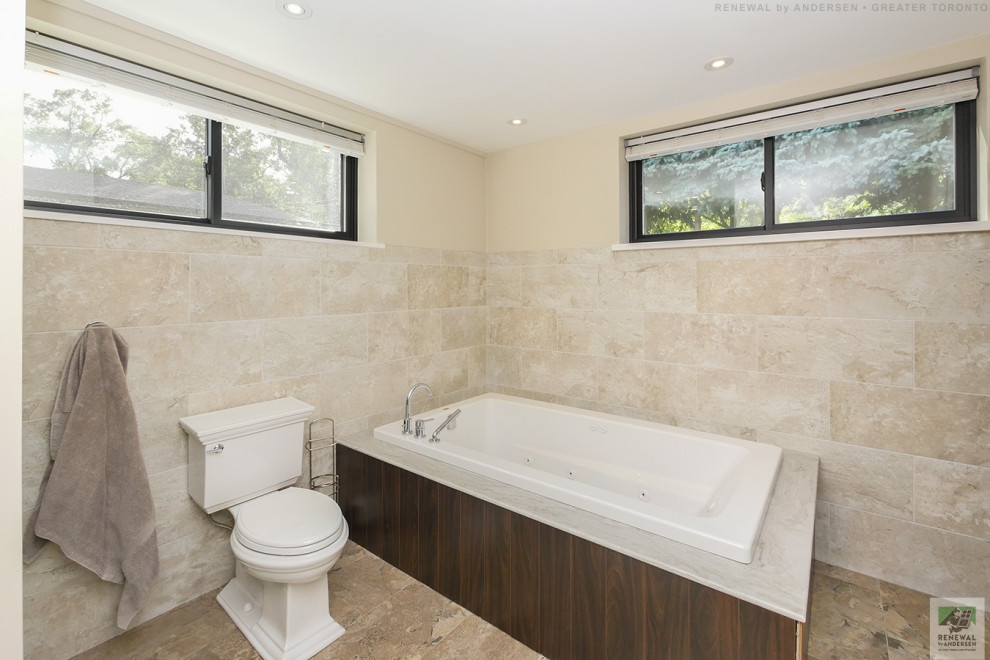 Design ideas for a mid-sized bathroom in Toronto with a hot tub, a corner shower, a two-piece toilet, beige tile, ceramic tile, beige walls, marble floors, an undermount sink, engineered quartz benchtops, beige floor, a hinged shower door, white benchtops, a single vanity and a built-in vanity.