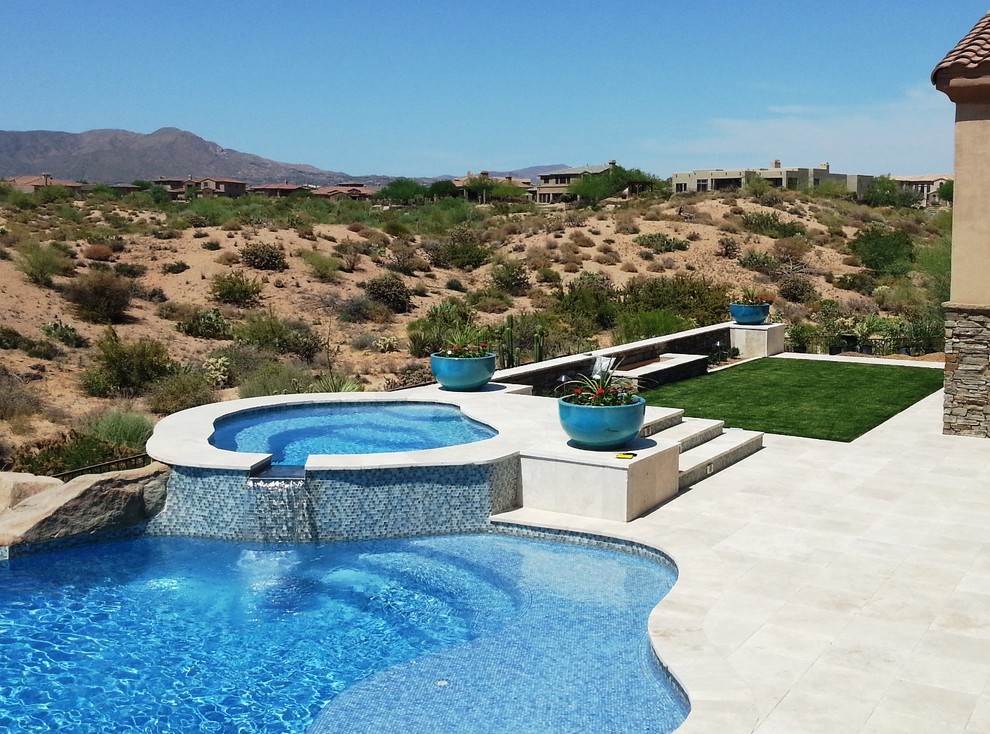 Design ideas for a mediterranean custom-shaped pool in Phoenix.