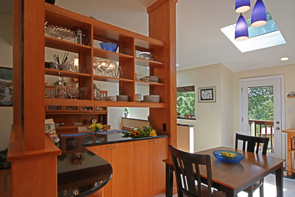 Photo of a mid-sized midcentury single-wall eat-in kitchen in St Louis with an undermount sink, flat-panel cabinets, brown cabinets, granite benchtops, white splashback, ceramic splashback, stainless steel appliances and linoleum floors.