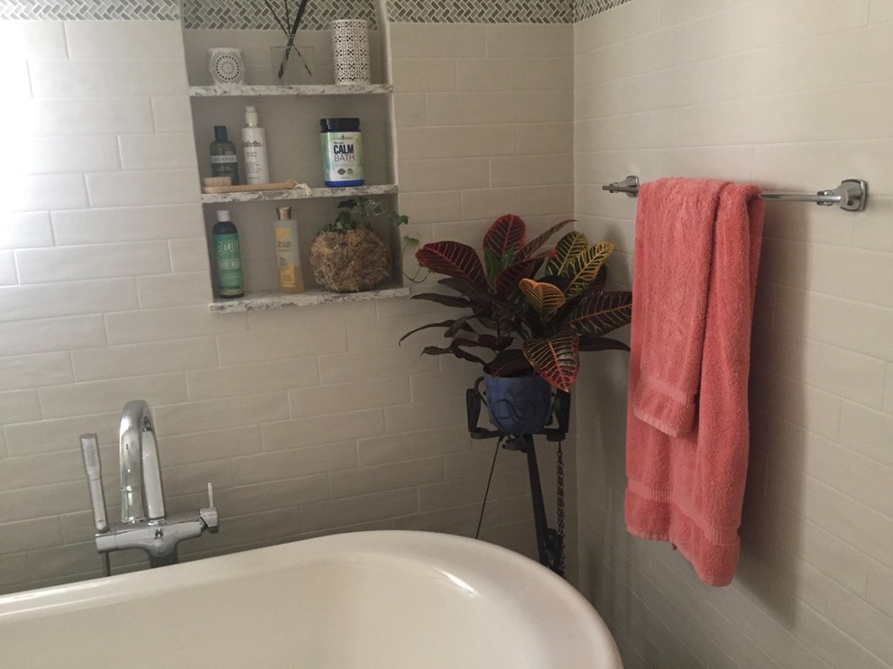 Mid-sized mediterranean 3/4 bathroom in Los Angeles with furniture-like cabinets, white cabinets, a claw-foot tub, a shower/bathtub combo, a one-piece toilet, gray tile, subway tile, grey walls, cement tiles, an integrated sink, tile benchtops, grey floor and an open shower.