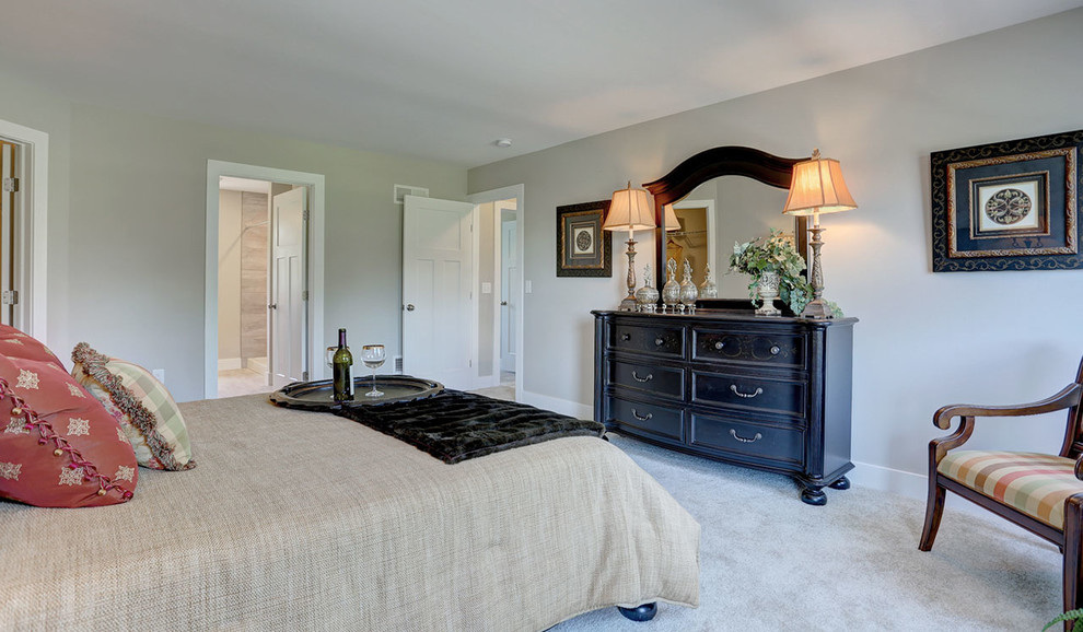 This is an example of a mid-sized country master bedroom in Other with beige walls, carpet and beige floor.