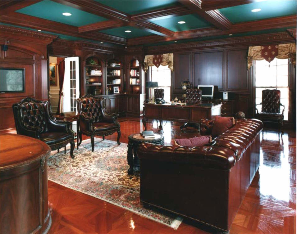 Large traditional study room in Chicago with brown walls and a freestanding desk.