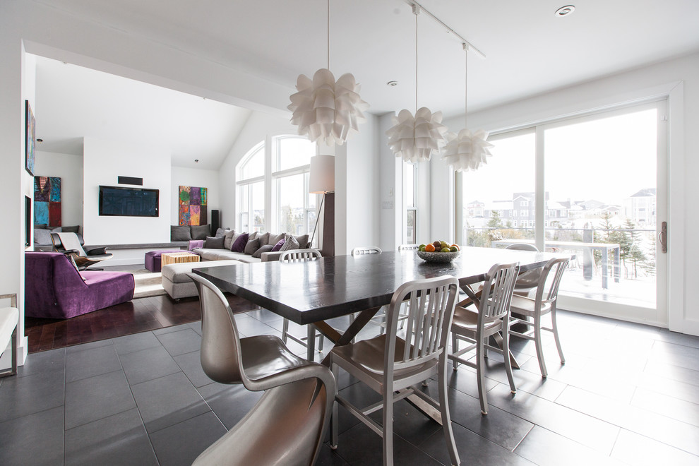 This is an example of a contemporary dining room in Other with white walls and slate floors.