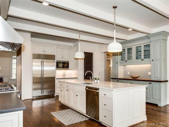 Transitional u-shaped separate kitchen in Charlotte with beaded inset cabinets, white cabinets, quartzite benchtops, white splashback, stainless steel appliances, medium hardwood floors and with island.