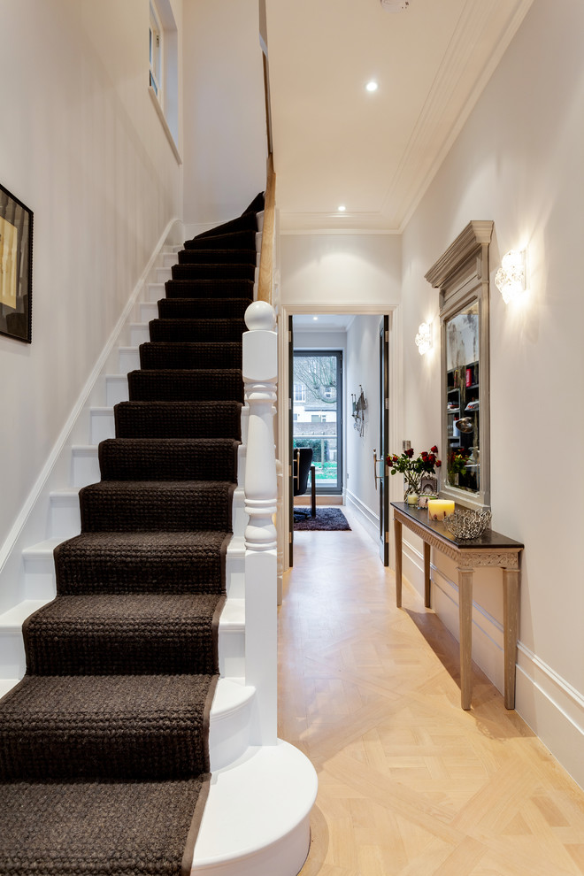 Photo of a small traditional wood l-shaped staircase in London with wood risers.