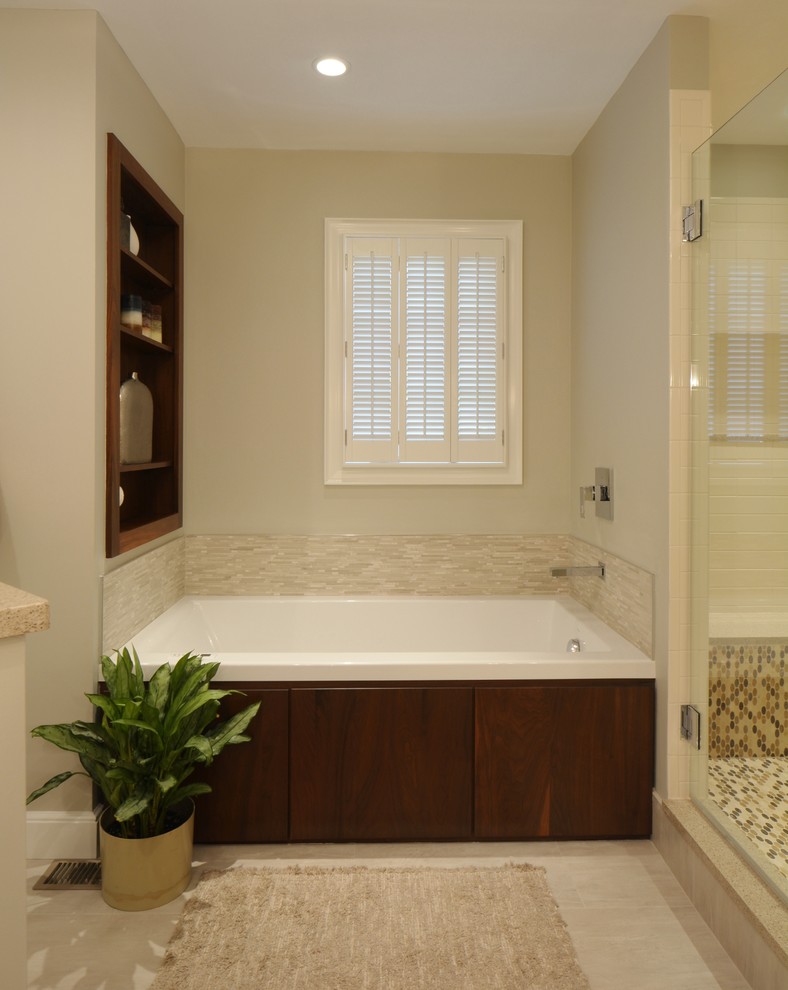 Design ideas for a contemporary bathroom in Boston with an undermount sink, flat-panel cabinets, medium wood cabinets, engineered quartz benchtops, an alcove tub, an alcove shower, beige tile and porcelain tile.