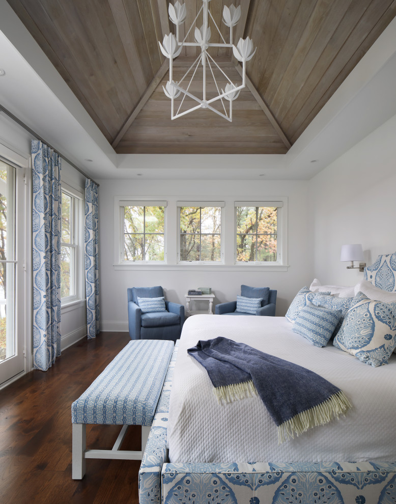 На фото: гостевая спальня (комната для гостей) в морском стиле с паркетным полом среднего тона, белыми стенами, коричневым полом, сводчатым потолком и деревянным потолком без камина