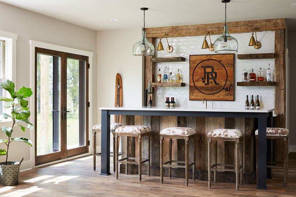 Large farmhouse galley breakfast bar in Minneapolis with a submerged sink, shaker cabinets, black cabinets, engineered stone countertops, white splashback, metro tiled splashback, vinyl flooring, grey floors, white worktops and feature lighting.