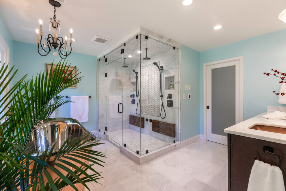This is an example of a small contemporary master bathroom in DC Metro with dark wood cabinets, a freestanding tub, a double shower, a one-piece toilet, blue walls, marble floors, marble benchtops, grey floor, a hinged shower door, white benchtops, a shower seat, a double vanity and a floating vanity.