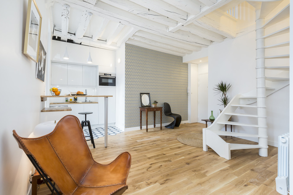 Photo of a mid-sized scandinavian open concept family room in Paris with light hardwood floors.