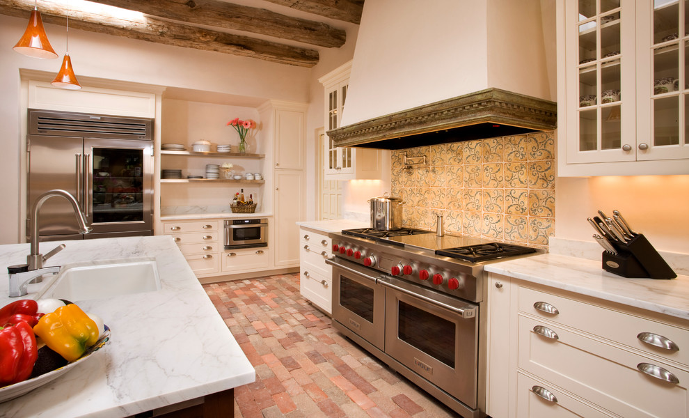 Design ideas for a country kitchen in Albuquerque with glass-front cabinets and stainless steel appliances.