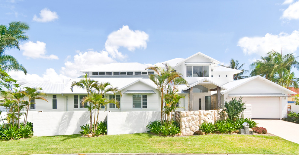 Beach style two-storey white house exterior in Gold Coast - Tweed with a gable roof.