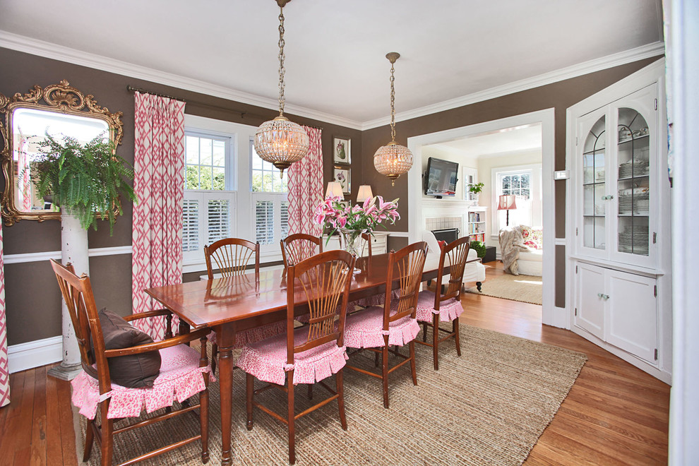 Traditional separate dining room in New York with brown walls, medium hardwood floors and no fireplace.
