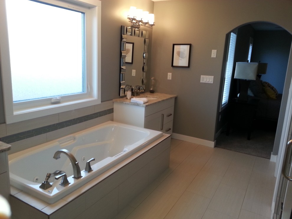 Inspiration for a large transitional master vinyl floor alcove shower remodel with shaker cabinets, white cabinets, beige walls, an undermount sink and granite countertops