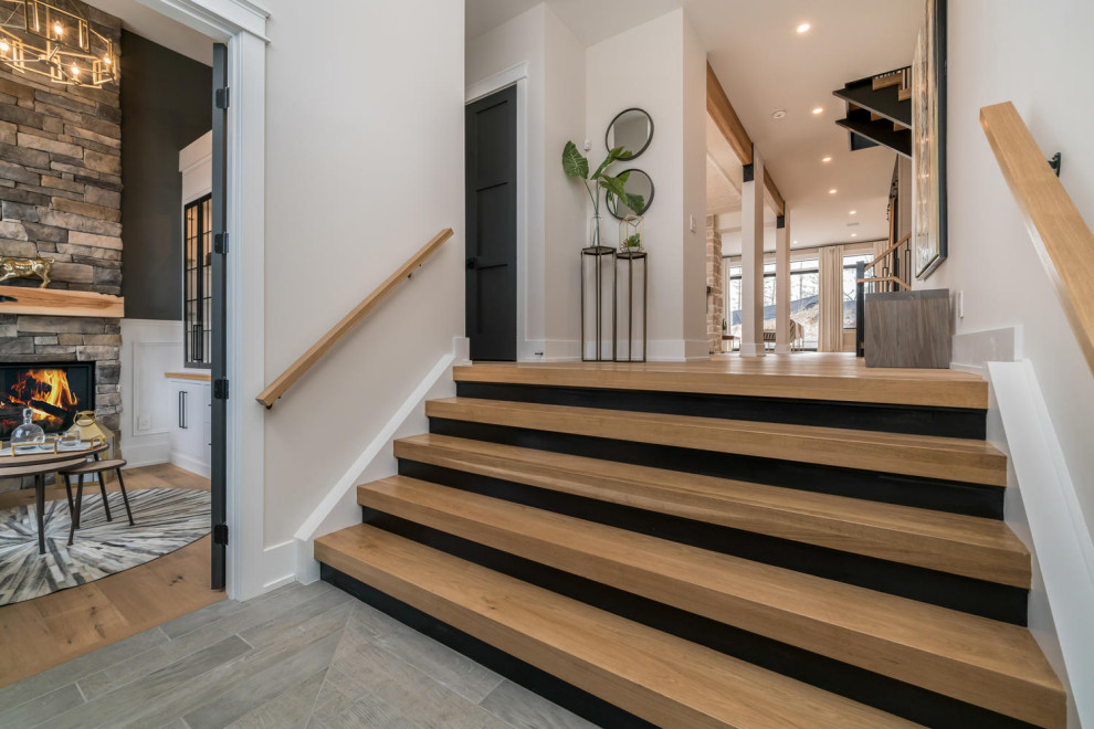 Example of a large transitional gray floor foyer design in Toronto with white walls