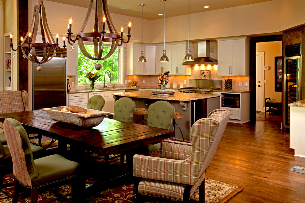 Example of a large mountain style l-shaped medium tone wood floor eat-in kitchen design in Minneapolis with an integrated sink, flat-panel cabinets, white cabinets, granite countertops, beige backsplash, ceramic backsplash, stainless steel appliances and an island