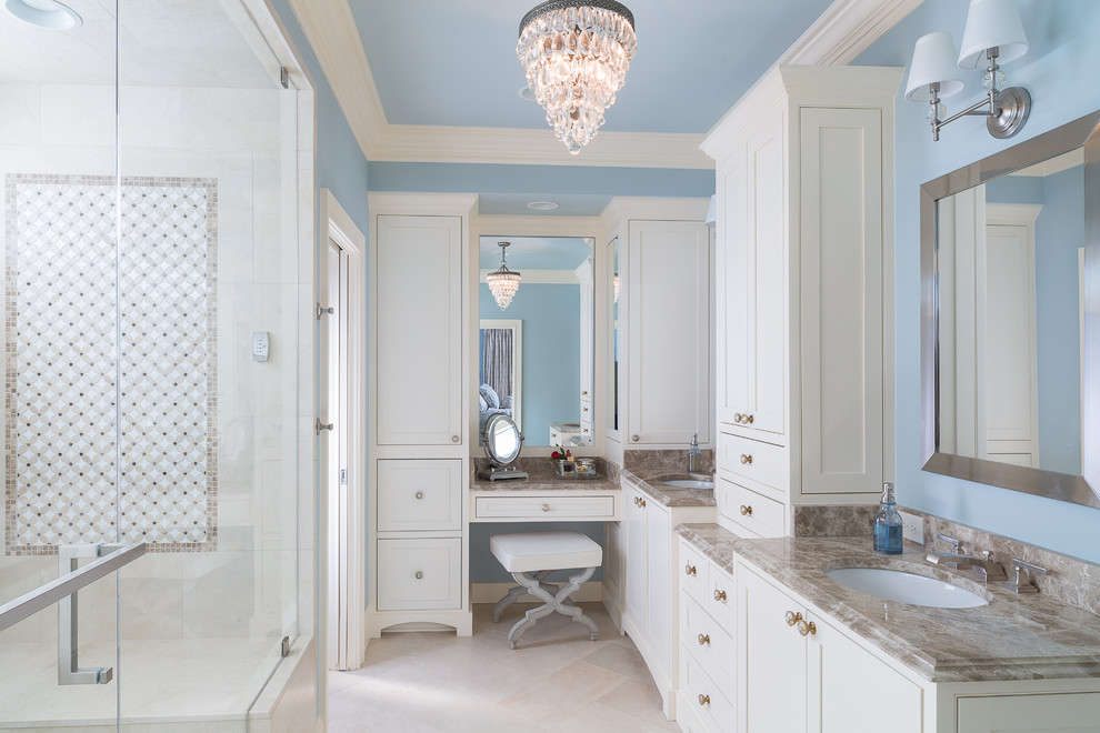 Inspiration for a traditional master bathroom in Atlanta with an undermount sink, shaker cabinets, white cabinets, marble benchtops, stone tile, blue walls, marble floors and beige tile.