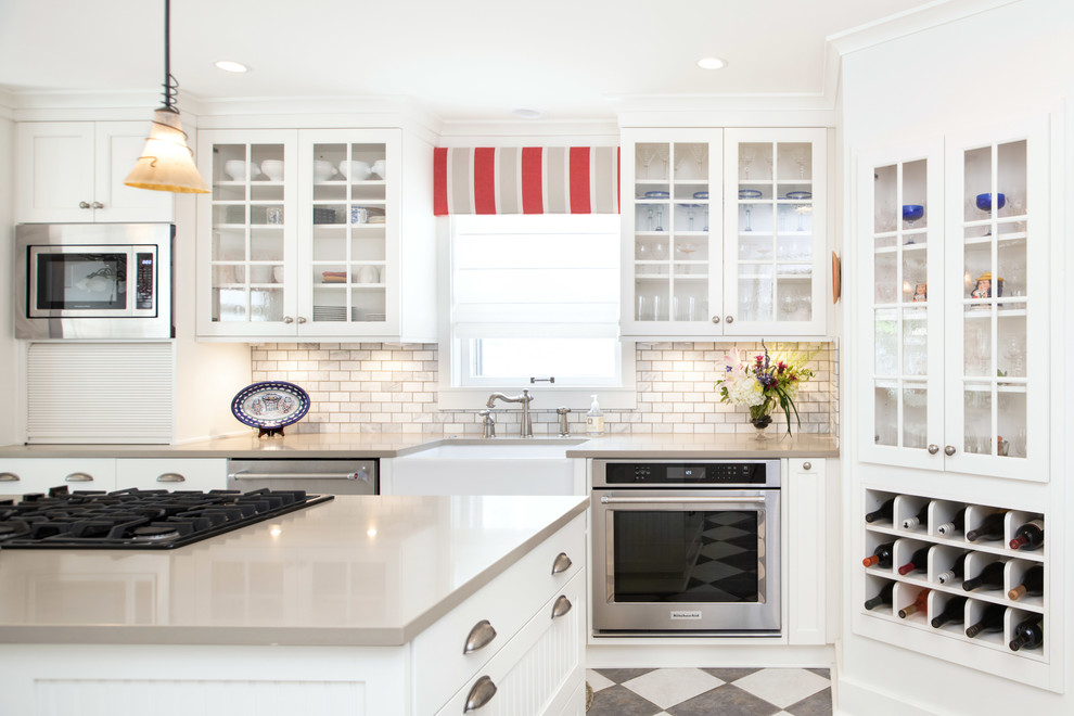 Design ideas for a small transitional single-wall separate kitchen in Kansas City with a farmhouse sink, shaker cabinets, white cabinets, quartz benchtops, marble splashback, stainless steel appliances, cement tiles, with island and grey benchtop.