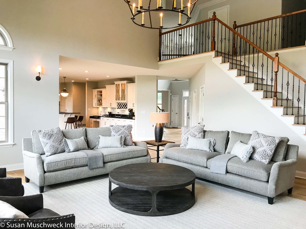 Inspiration for a large transitional open concept light wood floor home design remodel with white walls