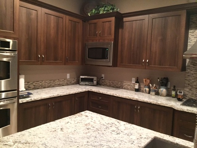 Open concept kitchen - mid-sized transitional l-shaped limestone floor and beige floor open concept kitchen idea with an undermount sink, shaker cabinets, dark wood cabinets, granite countertops, multicolored backsplash, matchstick tile backsplash, stainless steel appliances and an island