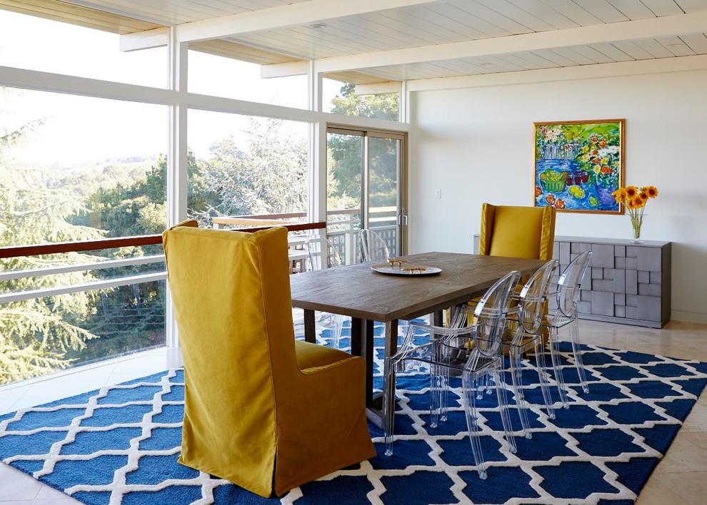 Photo of a midcentury separate dining room in San Francisco with white walls and travertine floors.
