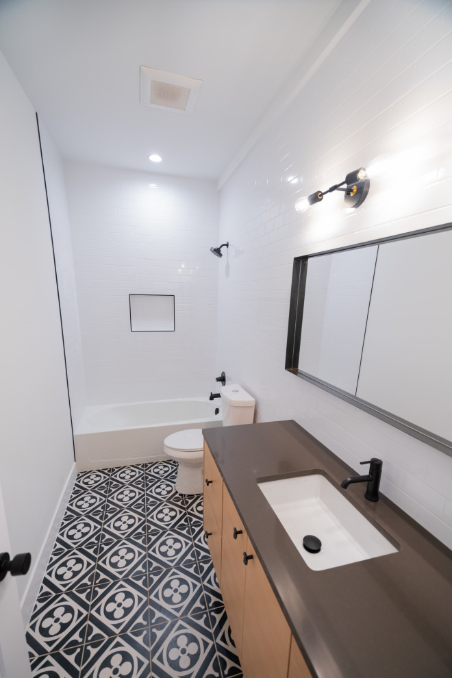 Example of a mid-sized minimalist kids' white tile and porcelain tile ceramic tile, gray floor and single-sink bathroom design in Denver with flat-panel cabinets, light wood cabinets, a two-piece toilet, white walls, an undermount sink, quartzite countertops, black countertops and a floating vanity