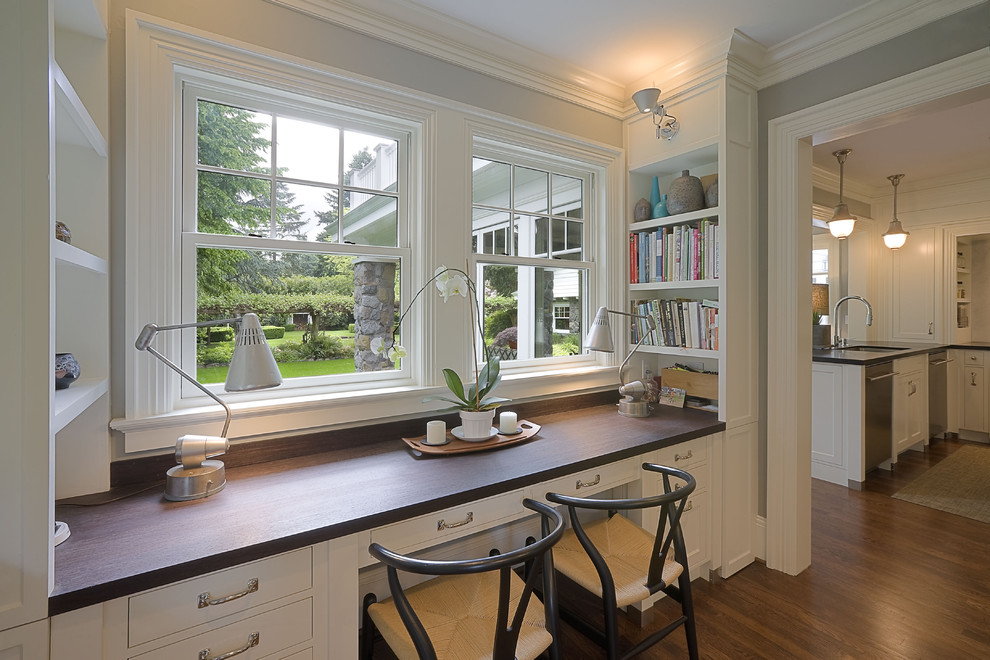 Traditional home office in Portland with grey walls, dark hardwood floors and a built-in desk.