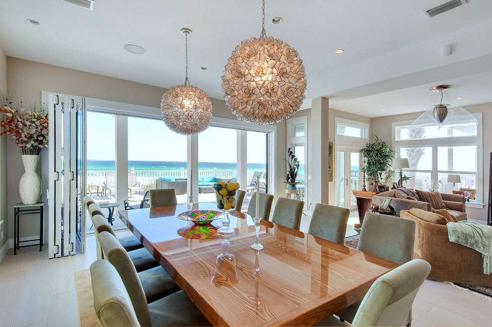 Photo of a large beach style open plan dining in Miami with white walls, porcelain floors and no fireplace.