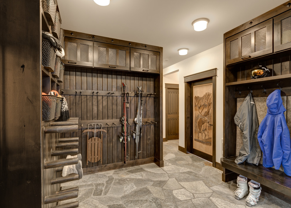Large country mudroom in Other with slate floors, grey floor and white walls.