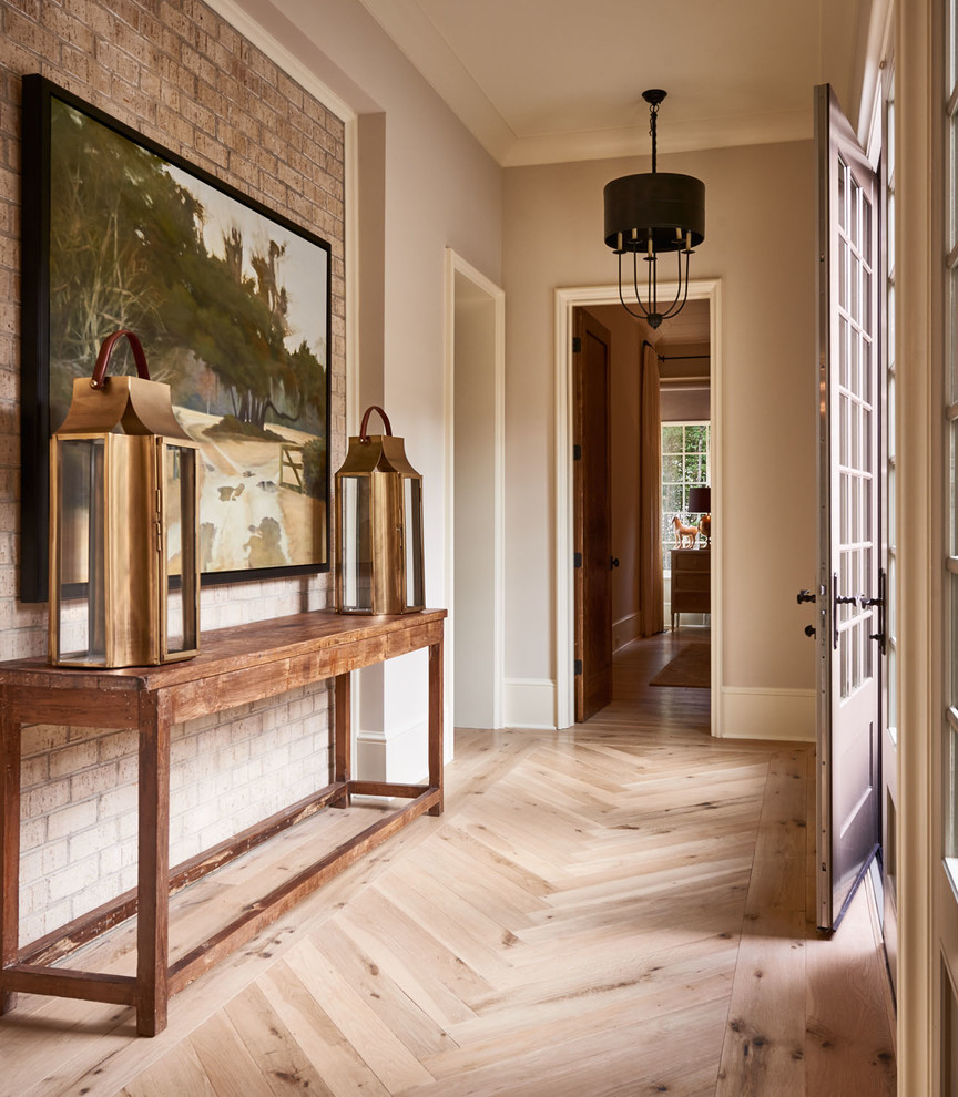 Design ideas for a mid-sized traditional hallway in Charlotte with beige walls, light hardwood floors and beige floor.
