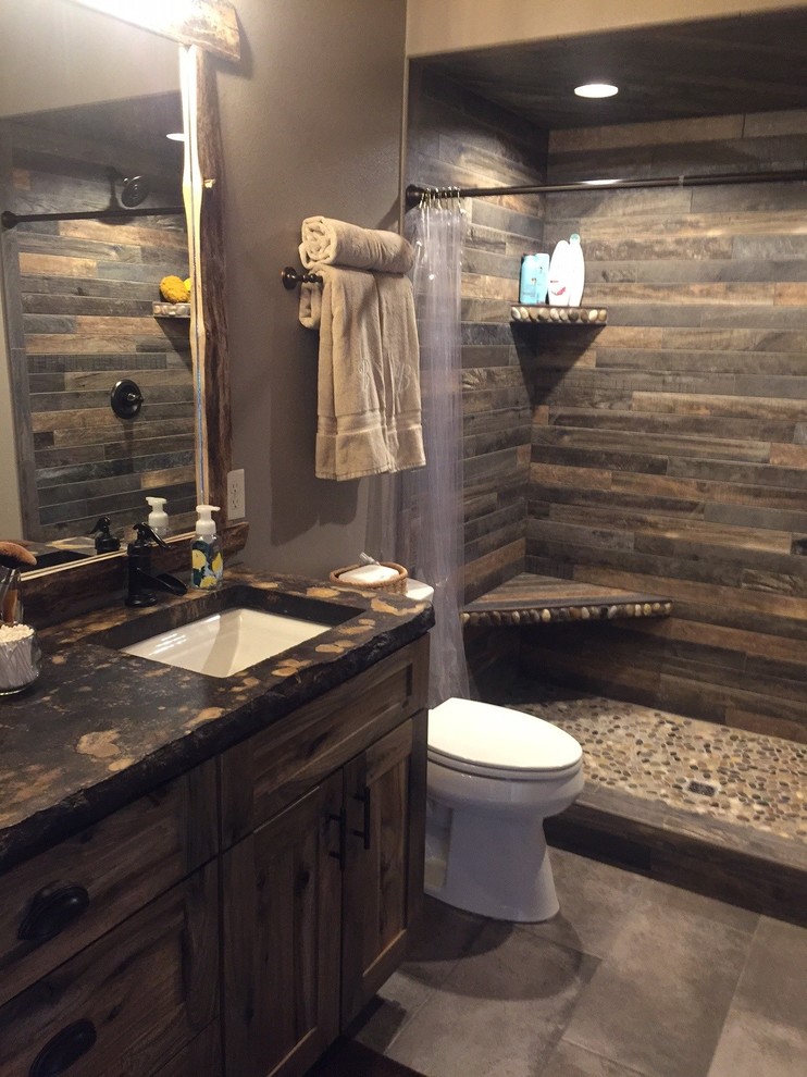 Photo of a small country master bathroom in Other with shaker cabinets, medium wood cabinets, an open shower, multi-coloured tile, porcelain tile, brown walls, porcelain floors, concrete benchtops and grey floor.