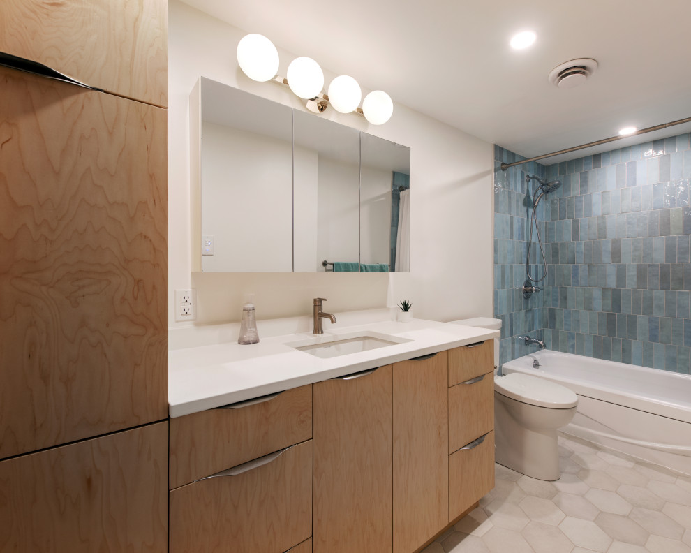 Inspiration for a mid-sized transitional l-shaped medium tone wood floor, gray floor and vaulted ceiling open concept kitchen remodel in Ottawa with a double-bowl sink, shaker cabinets, gray cabinets, quartz countertops, white backsplash, subway tile backsplash, stainless steel appliances, an island and white countertops
