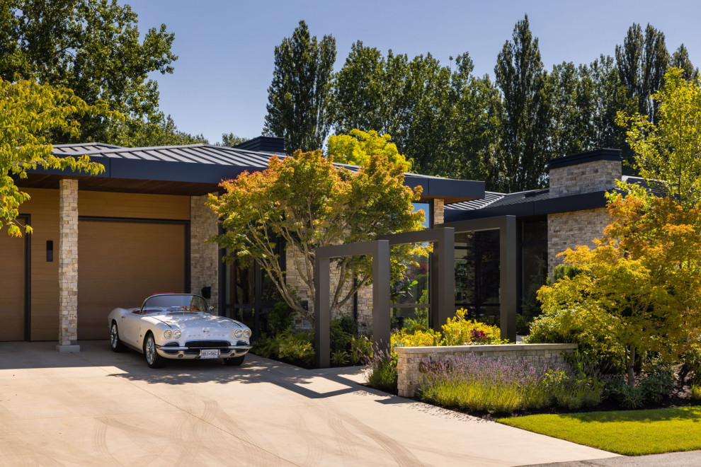 Design ideas for a large contemporary full sun front yard concrete paver formal garden in Vancouver.