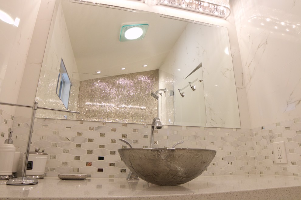 Example of a mid-sized transitional 3/4 gray tile, white tile and mosaic tile marble floor and white floor alcove shower design in Orange County with beaded inset cabinets, white cabinets, white walls, a vessel sink, quartz countertops and a hinged shower door